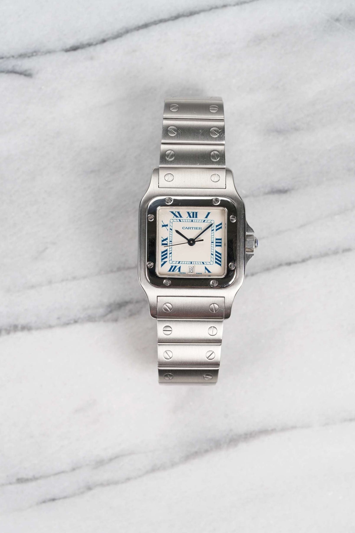 Steel Santos 1564 on its steel screw-link bracelet, here with blue-printed Roman numerals. · Photo: Danny's Vintage Watches · © Danny's Vintage Watches, used with permission · Source: https://dannysvintagewatches.com/products/cartier-santos-1564-blue-roman-dial-2