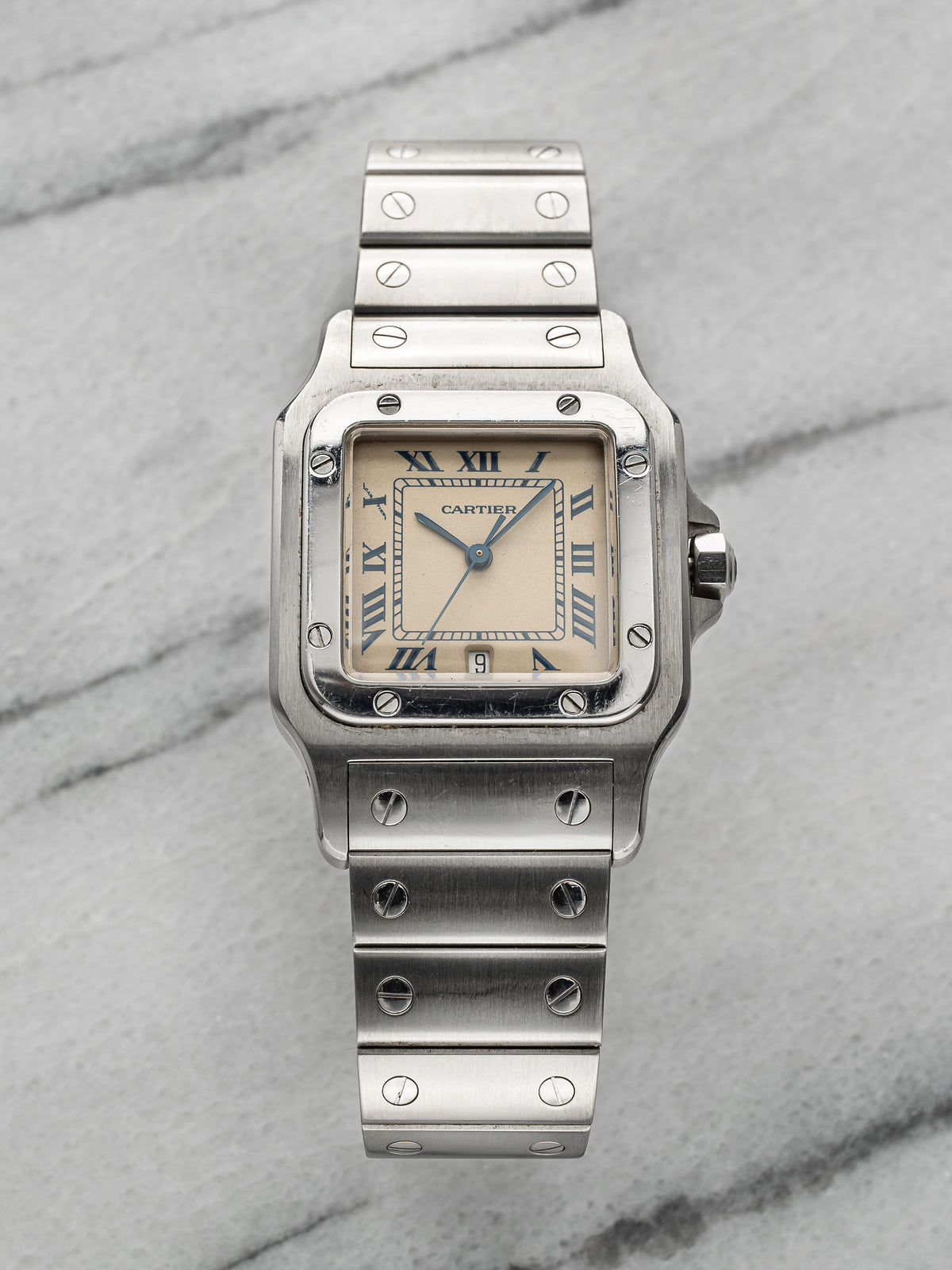 Steel Santos 1564 with a cream, ivory-toned dial, black Roman numerals and blued hands. · Photo: Danny's Vintage Watches · © Danny's Vintage Watches, used with permission · Source: https://dannysvintagewatches.com/products/cartier-santos-1564-cream-roman-dial