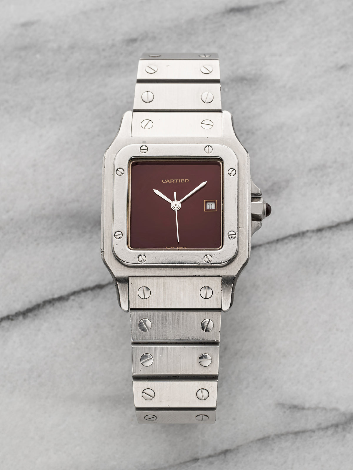 Steel Santos 2960 of 1983 with the burgundy lacquer dial, no numerals, date at three, on the steel bracelet. · Photo: Danny's Vintage Watches · © Danny's Vintage Watches, used with permission · Source: https://dannysvintagewatches.com/products/1983-cartier-santos-2960-burgundy-dial