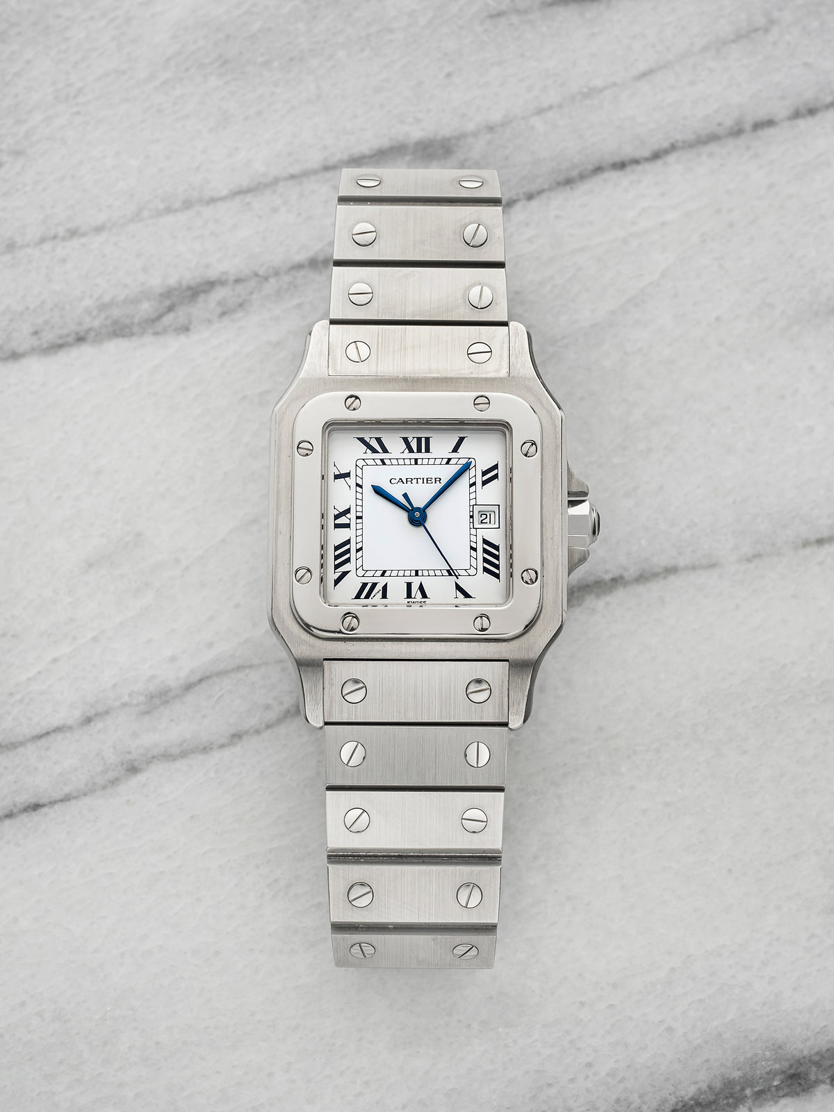 Steel Santos Carrée 2960 on its steel screw bracelet with the white Roman dial and blued sword hands. · Photo: Danny's Vintage Watches · © Danny's Vintage Watches, used with permission · Source: https://dannysvintagewatches.com/products/cartier-santos-carree-2960-stainless-steel-white-roman-dial-1