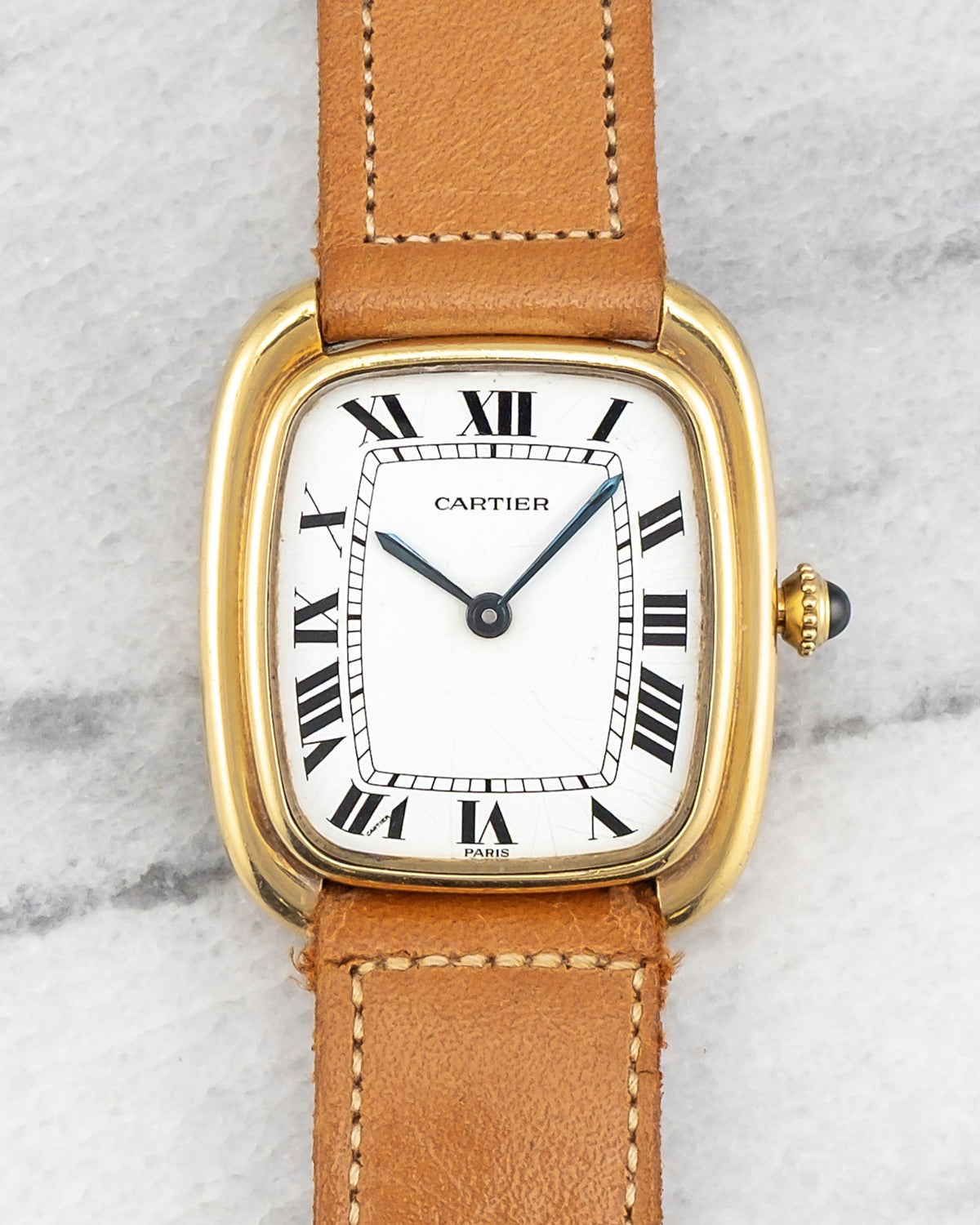Self-winding gold Gondolo of the 1980s with white Roman dial signed Paris and blued hands. · Photo: Danny's Vintage Watches · © Danny's Vintage Watches, used with permission · Source: https://dannysvintagewatches.com/products/vintage-cartier-gondolo-automatique-80s-white-roman-dial-18k-yellow-gold-case