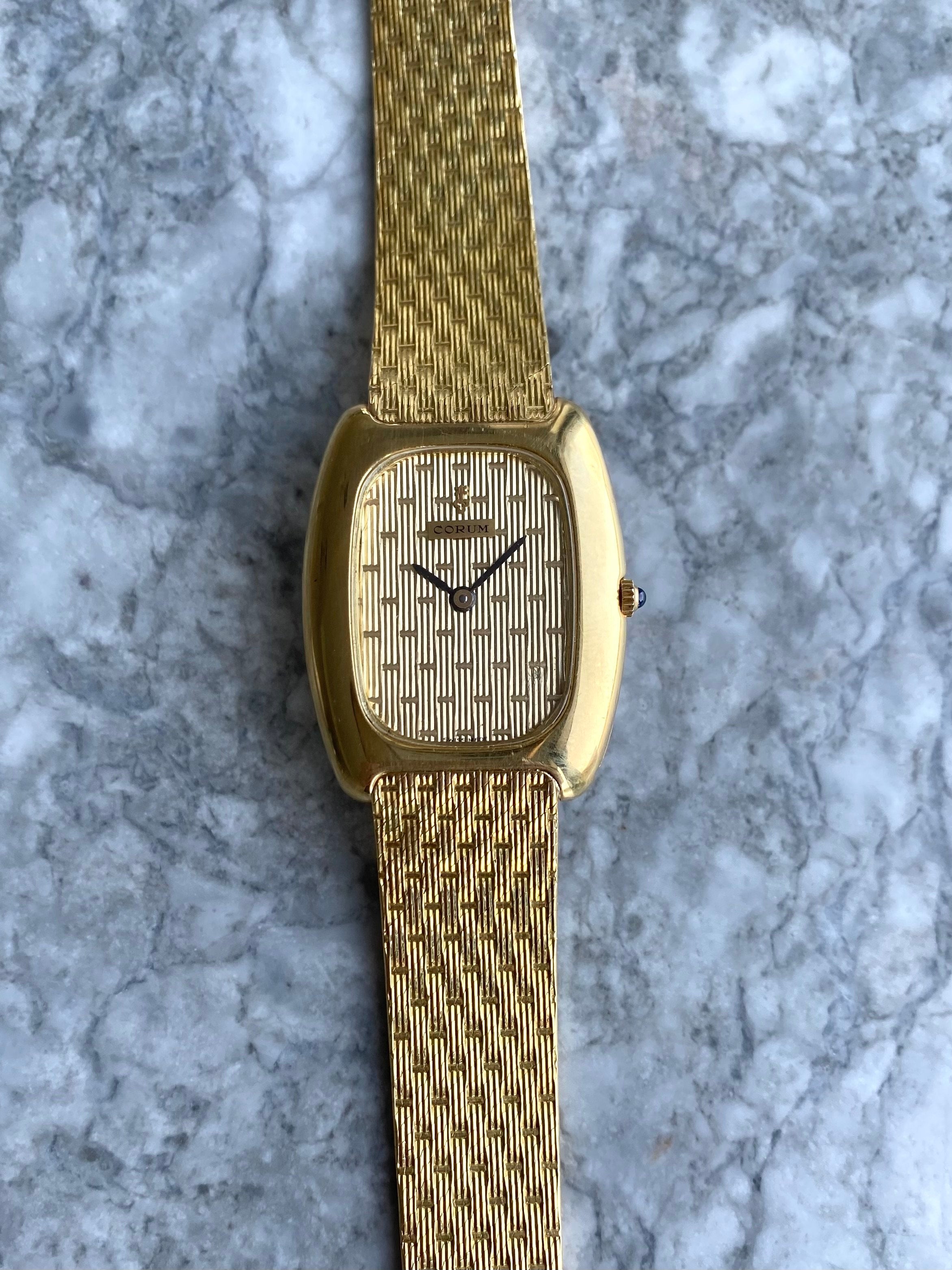 Corum - 18K Yellow Gold.