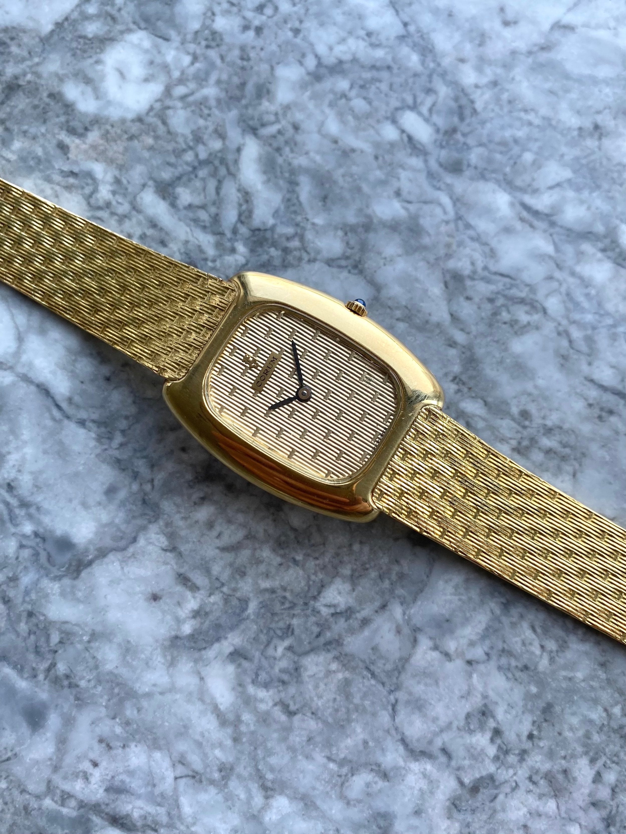 Corum - 18K Yellow Gold.